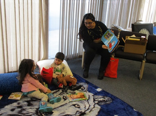 Nancy is reading a story to two children